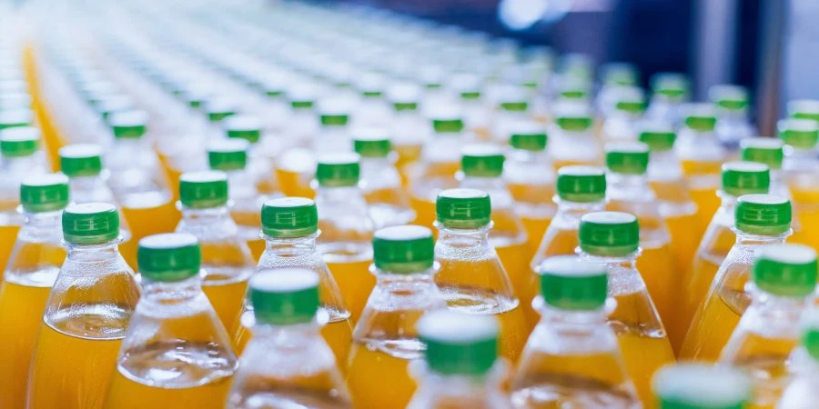 Conveyor with bottles for juice or water. Beverages factory